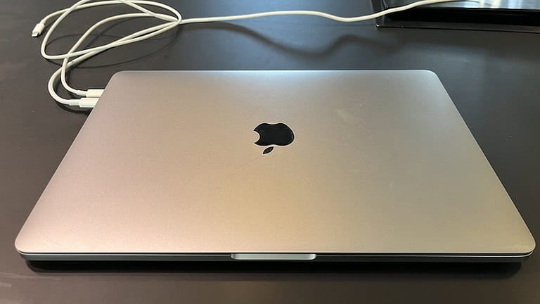 A closed MacBook screen on a table